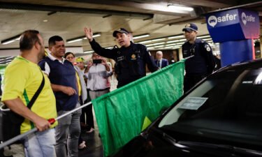Bolsonaro supporters and members of the Brazilian security services at Brasilia airport on Thursday.