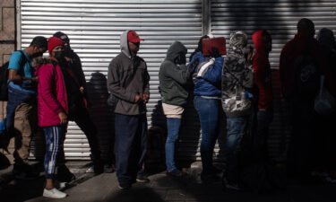 Migrants wait in line outside at the Mexican Commission for Refugee Assistance in Mexico City