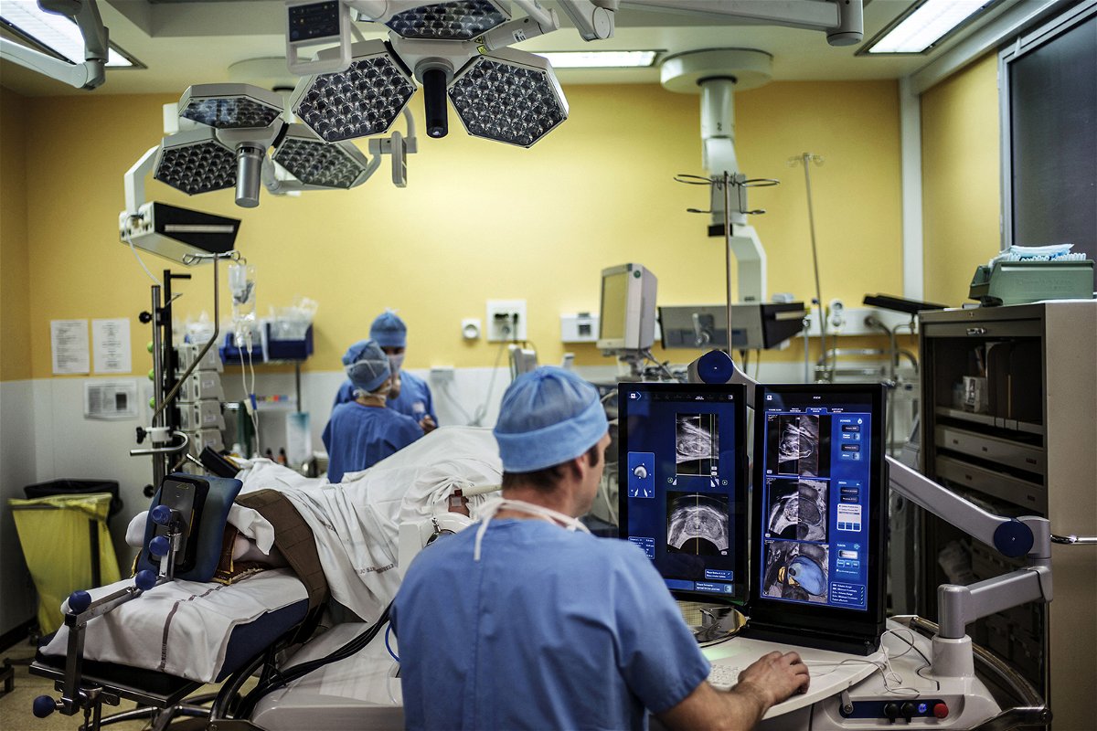 <i>Jeff Pachoud/AFP/Getty Images/File</i><br/>A surgeon sitting in front of screens of a Focal One device performs a robot-assisted prostate tumorectomy using ultrasound imaging on April 10