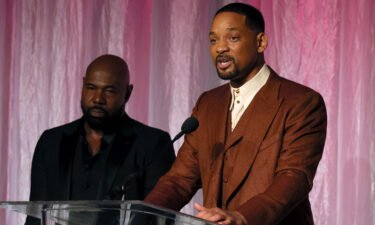 Honorees Antoine Fuqua (left) and Will Smith accept The Beacon Award for "Emancipation" onstage during the 14th Annual AAFCA Awards on Wednesday.