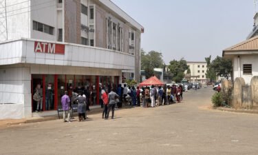 Nigerians queue for new banknotes at an ATM in the capital Abuja