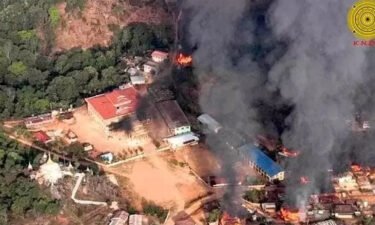A Myanmar monastery attack kills 22 as conflicting accounts emerge of the alleged massacre. The monastery and homes in Nan Neint village are pictured burning after a raid by Myanmar junta troops.