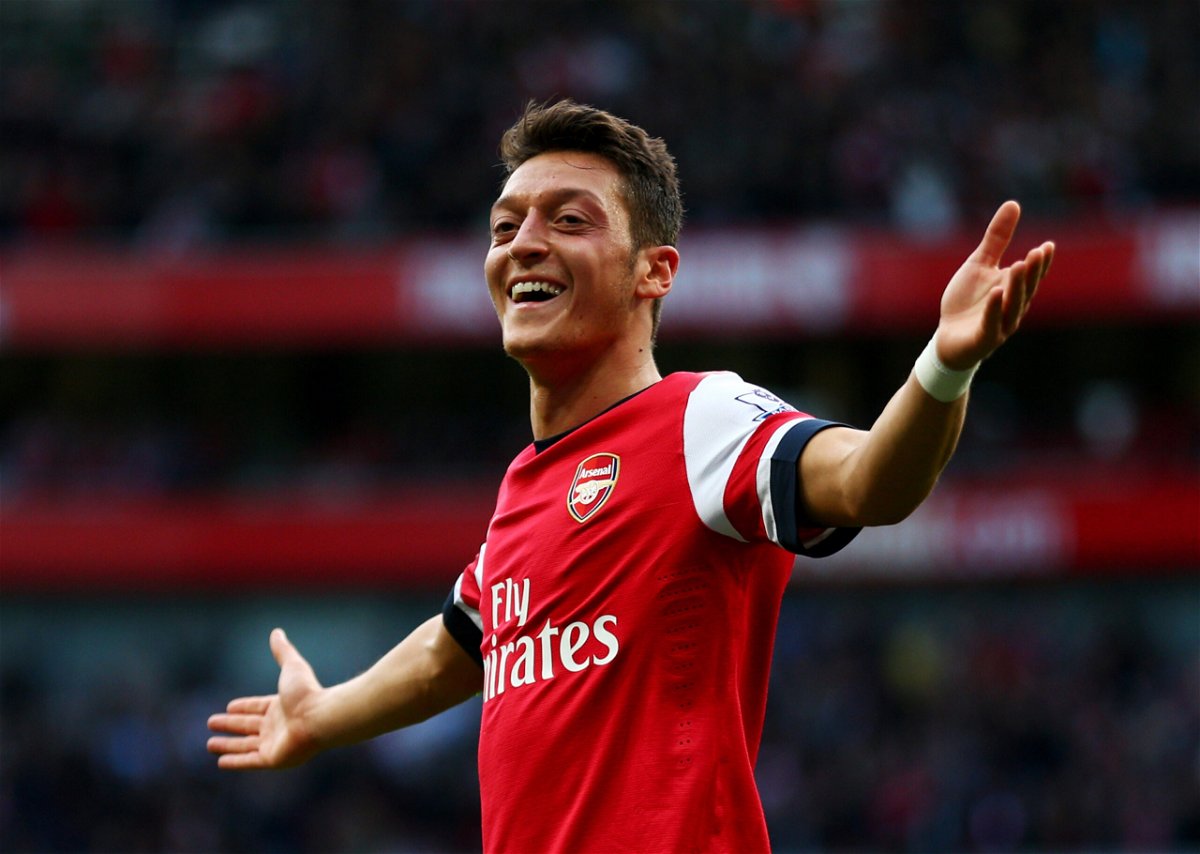 <i>Paul Gilham/Getty Images/FILE</i><br/>Özil celebrates scoring for Arsenal against Norwich City in 2013.