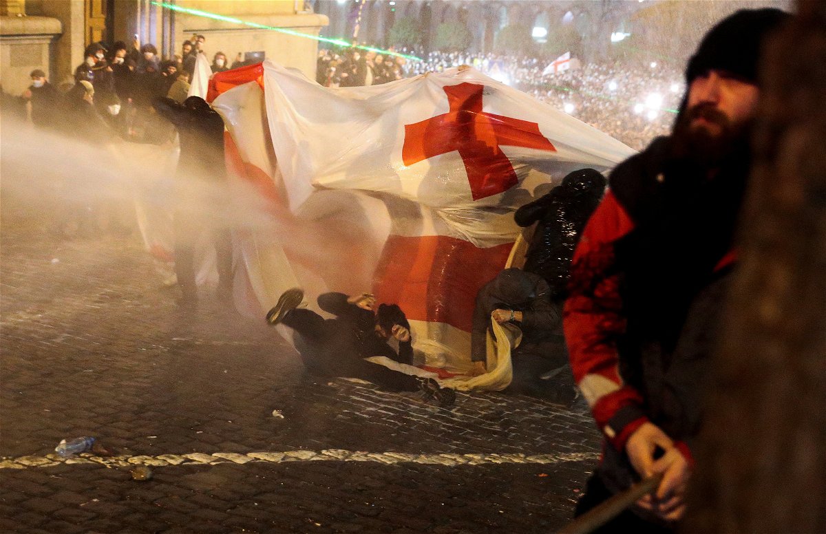 <i>Irakli Gedenidze/Reuters</i><br/>Police use a water cannon to disperse protesters.