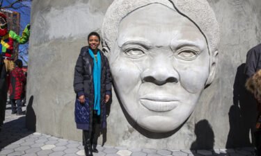 Architect Nina Cooke John stands with the Harriet Tubman monument she designed
