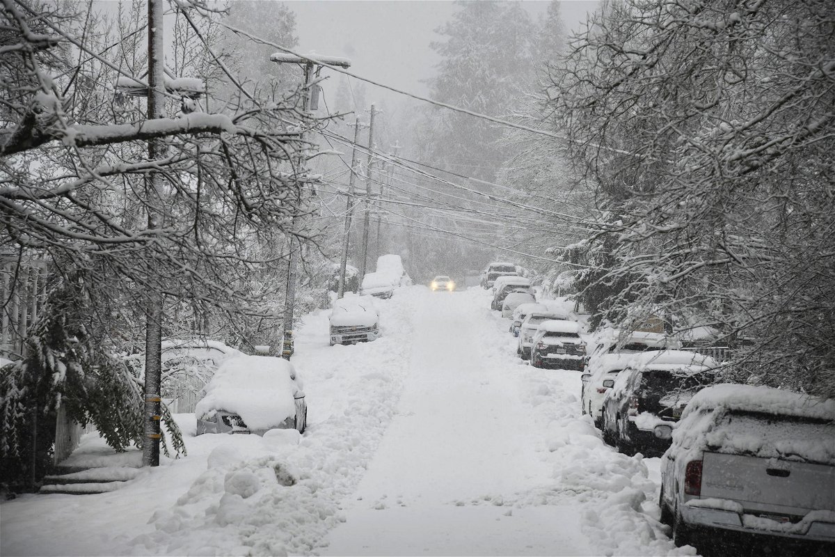 <i>Elias Funez/The Union/AP</i><br/>A vehicle attempts to drive along snow-covered Conaway Avenue in Grass Valley