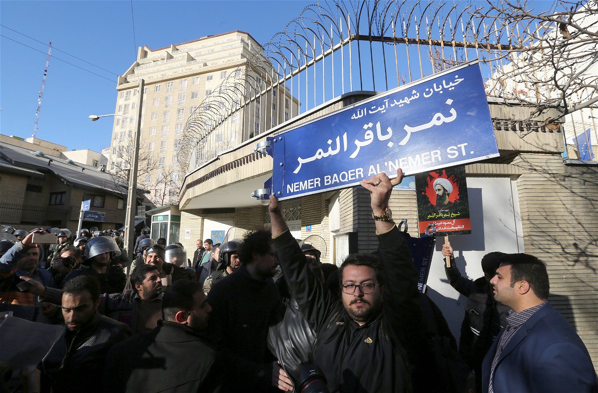 <i>Atta Kenare/AFP/Getty Images</i><br/>An Iranian protester holds a street sign bearing the name of prominent Shiite Muslim cleric Nimr al-Nimr during a demonstration against his execution by Saudi authorities
