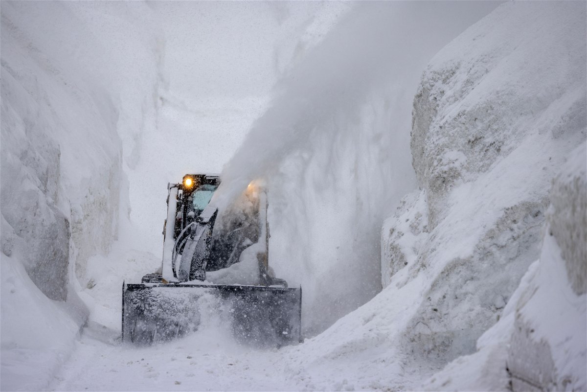 <i>David McNew/Getty Images</i><br/>A tractor blows snow from a street that is walled in by snow as it continues to deepen in the first days of spring on March 21