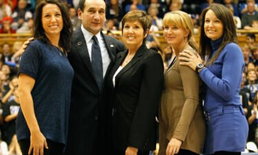 Mike Krzyzewski stands with his family as he is acknowledged for breaking the record for wins in NCAA men's basketball at Cameron Indoor Stadium in November