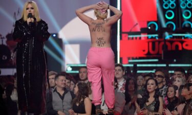 A naked protestor interrupts Avril Lavigne speaking onstage at the 2023 Juno Awards.