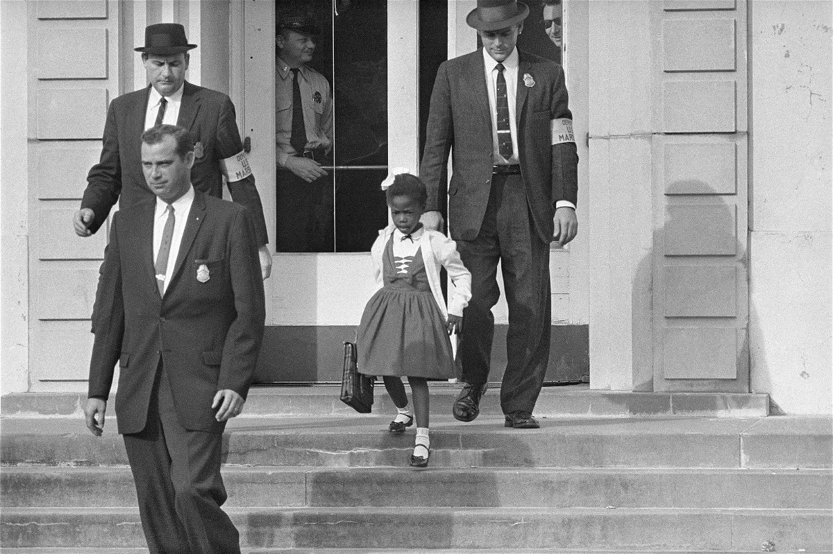 <i>AP/FILE</i><br/>US deputy marshals escort 6-year-old Ruby Bridges from William Frantz Elementary School in New Orleans in November 1960.
