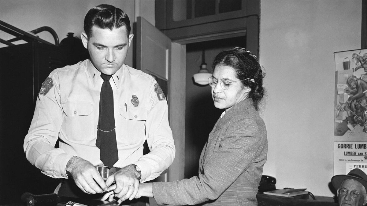 <i>Gene Herrick/AP/File</i><br/>Rosa Parks (right) was fingerprinted by police Lt. D.H. Lackey in Montgomery