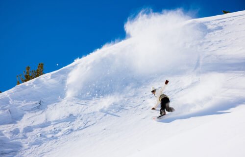 A snowboarder speeds down a run at Mammoth Mountain Ski Area.