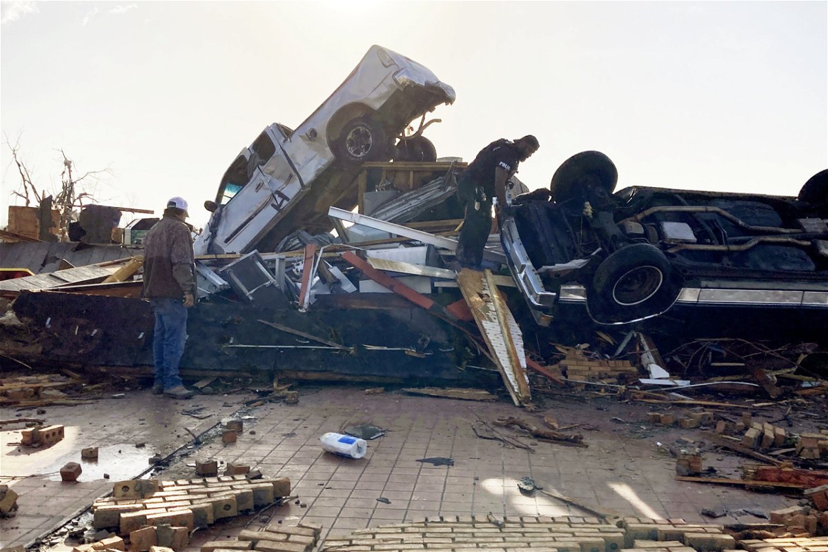 <i>Rogelio Solis/AP</i><br/>A police officer searches for survivors in the wreckage of a collapsed diner after a tornado leveled the small town of Rolling Fork