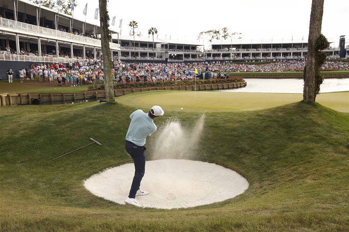 <i>Mike Ehrmann/Getty Images</i><br/>Scheffler plays a shot from a bunker on the 16th hole during the final round.