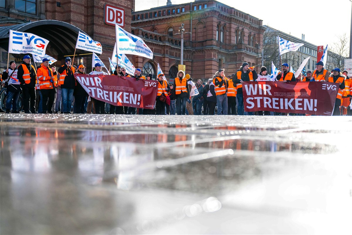 <i>Sina Schuldt/dpa/picture alliance/Getty Images</i><br/>Demonstrators of the Railway and Transport Union stand with placards in front of the main train station in Bremen