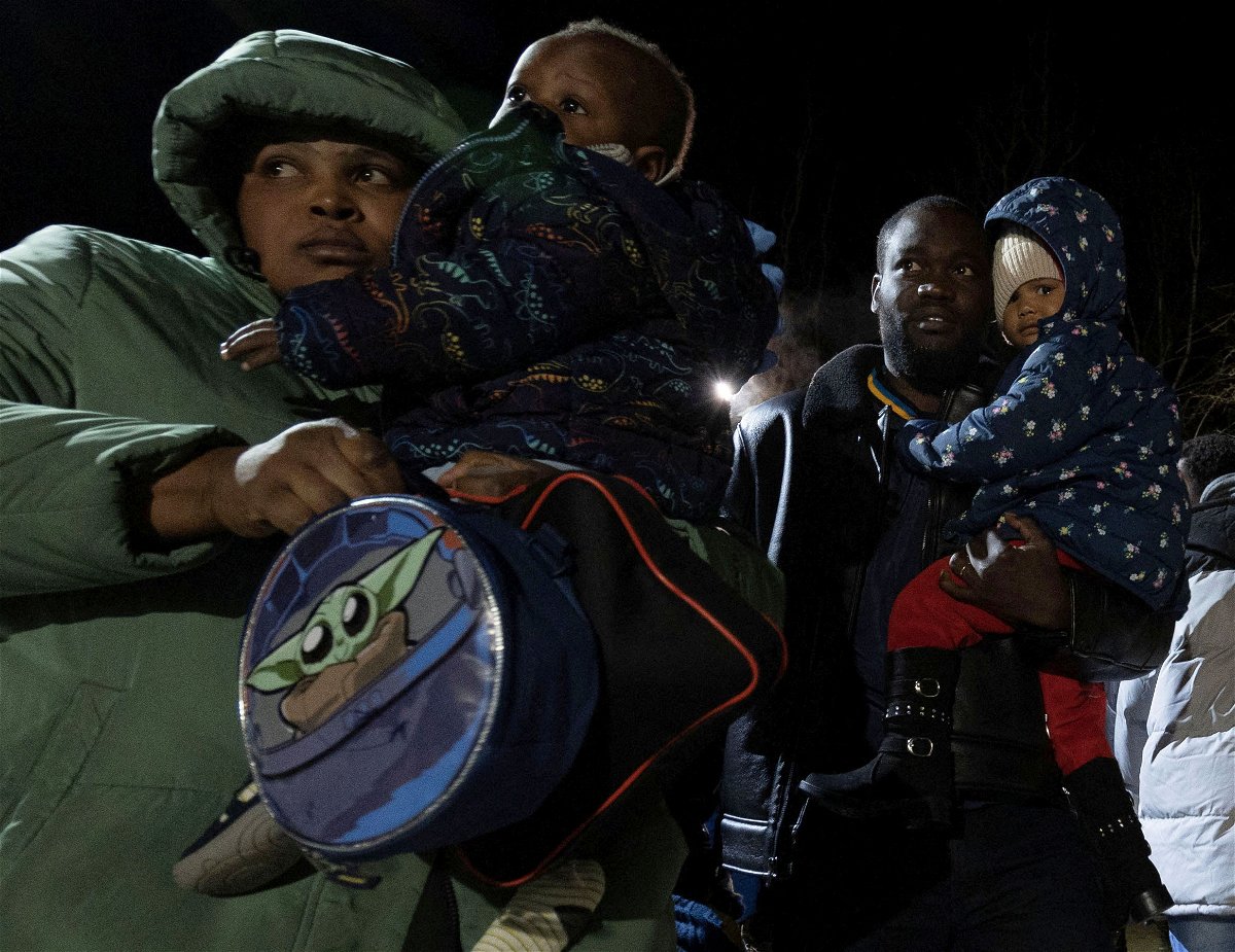 <i>Christinne Muschi/Reuters</i><br/>Migrants cross after midnight into Canada at Roxham Road