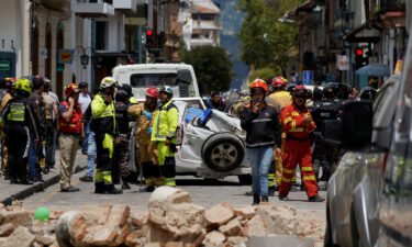 A damaged car and rubble from a house affected by the earthquake are pictured in Cuenca