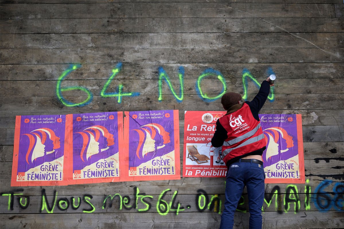 <i>Loic Venance/AFP/Getty Images</i><br/>An anti-pension reform demonstrator writes 