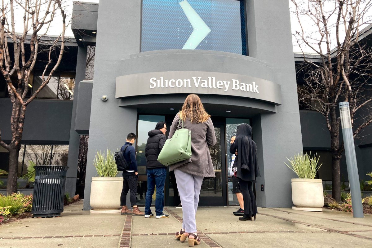<i>Jeff Chiu/AP</i><br/>People stand outside of an entrance to Silicon Valley Bank in Santa Clara