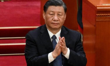 China's leader Xi Jinping applauds during the fifth plenary session of the National People's Congress (NPC) at the Great Hall of the People in Beijing on March 12.