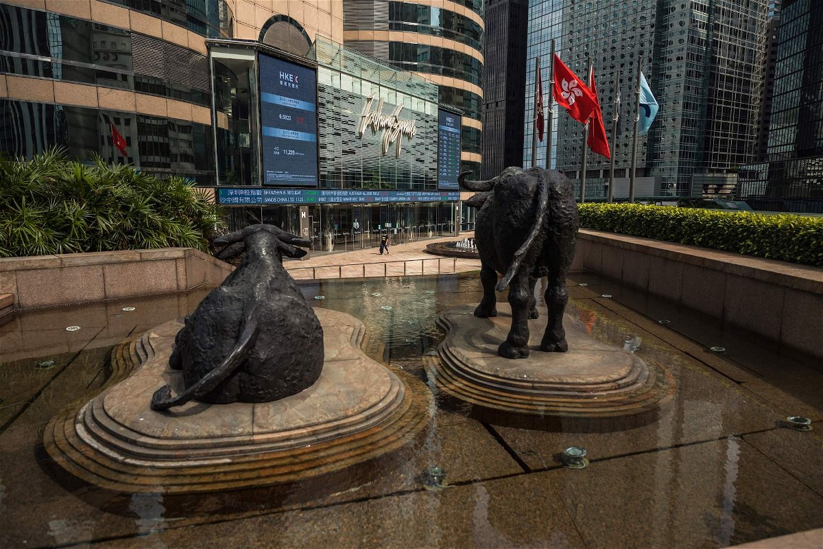 <i>Dale de la Ray/AFP/Getty Images/FILE</i><br/>A woman walks past Exchange Square which houses the Hong Kong Stock Exchange in Hong Kong on April 27