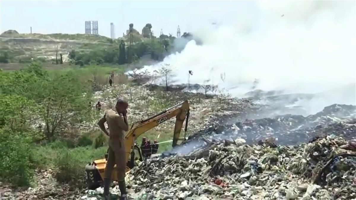 <i>Reuters</i><br/>Firefighters work to put out a blaze at the Brahmapuram plant landfill in Kochi