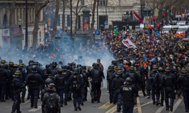 Riot police face protesters during a demonstration as part of a nationwide strike against pension reform in central Paris on Thursday.