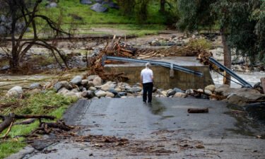 5 things to know for March 15 includes California flooding. An onlooker is pictured checking out the damage after the fast moving and swollen Tulare River crumbled parts of Globe Drive on March 14