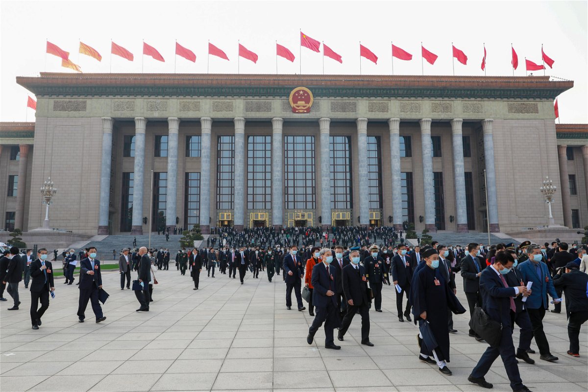 <i>Visual China Group/Getty Images</i><br/>People walk in front of the Great Hall of the People on March 4