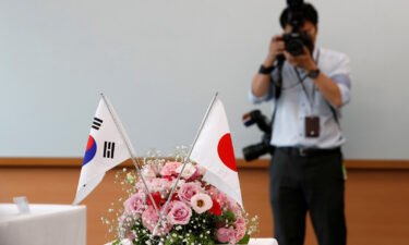 South Korea and Japan have on Monday announced a deal to ease strains over wartime labor dispute. The two countries' flags are here displayed in Tokyo
