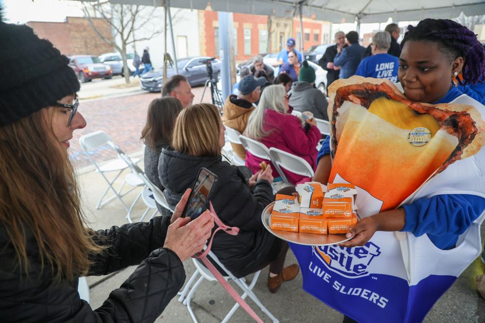 <i>The Times</i><br/>Jill Banik (left) takes a photo of Z'satrice Lott as she distributes White Castle cheeseburgers Tuesday during the last-day commemoration at the historic building in Whiting.