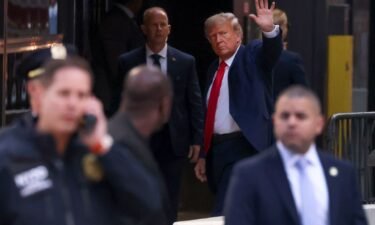 Former President Donald Trump waves to supporters upon arriving at Trump Tower in New York on April 3. Trump is in New York for an expected arraignment on April 4.