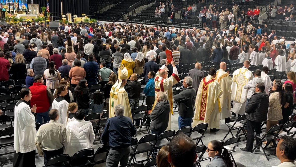 The procession as Masses of Idaho Falls, Mud Lake, and Roberts united into a single Mass at the Mountain America Center.
