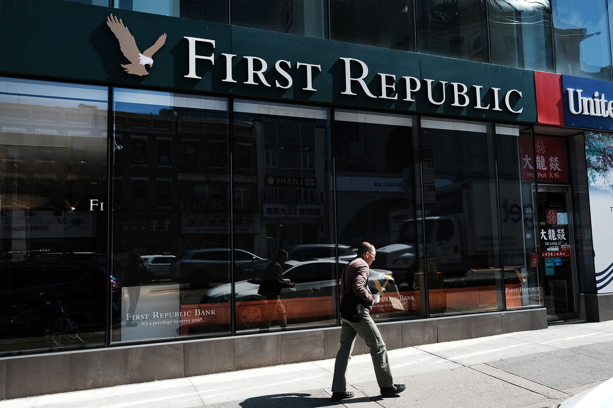 <i>Spencer Platt/Getty Images</i><br/>A person walks past a First Republic bank branch in Manhattan on April 24.