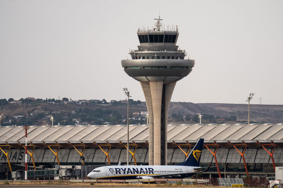 <i>Marcos del Mazo/LightRocket/Getty Images</i><br/>A Ryanair airplane in seen on the runway at Adolfo Suarez Madrid Barajas Airport passing by the air traffic control tower.