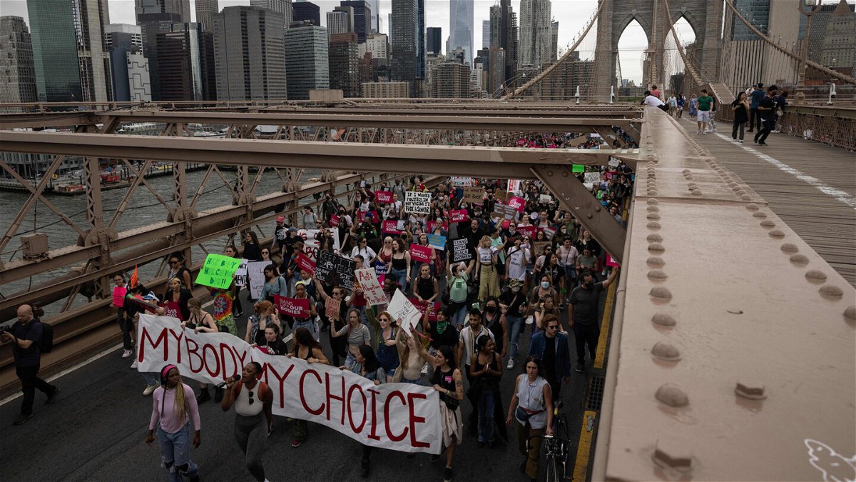 <i>Yuki Iwamura/AFP/Getty Images</i><br/>Abortion rights demonstrators walk across the Brooklyn Bridge in New York nearly two weeks after the leak of a draft Supreme Court opinion that would overturn Roe v. Wade.