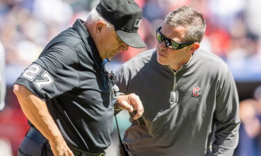 Cleveland Guardians trainer James Quinlan (right) looks after Umpire Larry Vanover after Vanover was hit with a baseball during a game between the Guardians and the New York Yankees at Progressive Field in Cleveland on April 12.