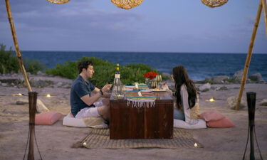 Love is Blind's Zach and Irina sit for dinner in a recent episode.