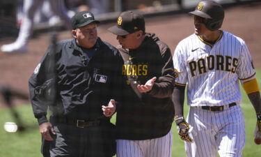 San Diego Padres manager Bob Melvin (center) talks with an umpire as Machado is being ejected.