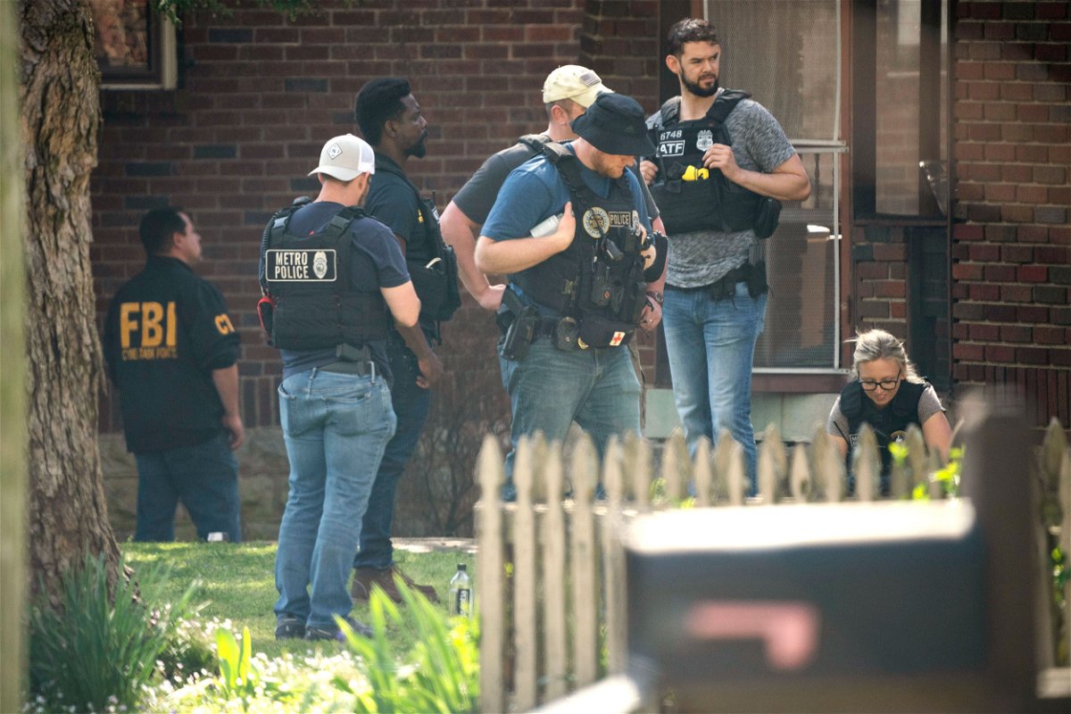 <i>Andrew Nelles/The Tennessean/AP</i><br/>Metro Nashville Police and the FBI search and investigate a house following a mass shooting at Covenant School
