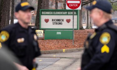 Police look on as students return to Richneck Elementary in Newport News