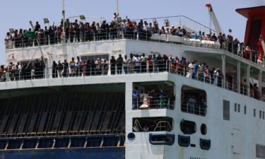 Evacuees stand on a ferry as it transports some people across the Red Sea from Port Sudan to the Saudi King Faisal navy base in Jeddah