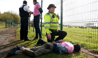 Protesters are detained by police on April 15.