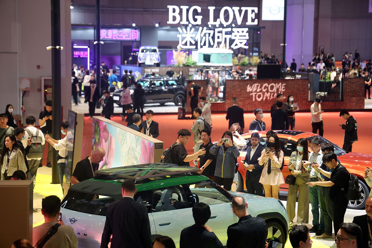 <i>VCG/Visual China Group/Getty Images</i><br/>People visit the Mini Cooper booth at the Shanghai International Automobile Industry Exhibition on April 18