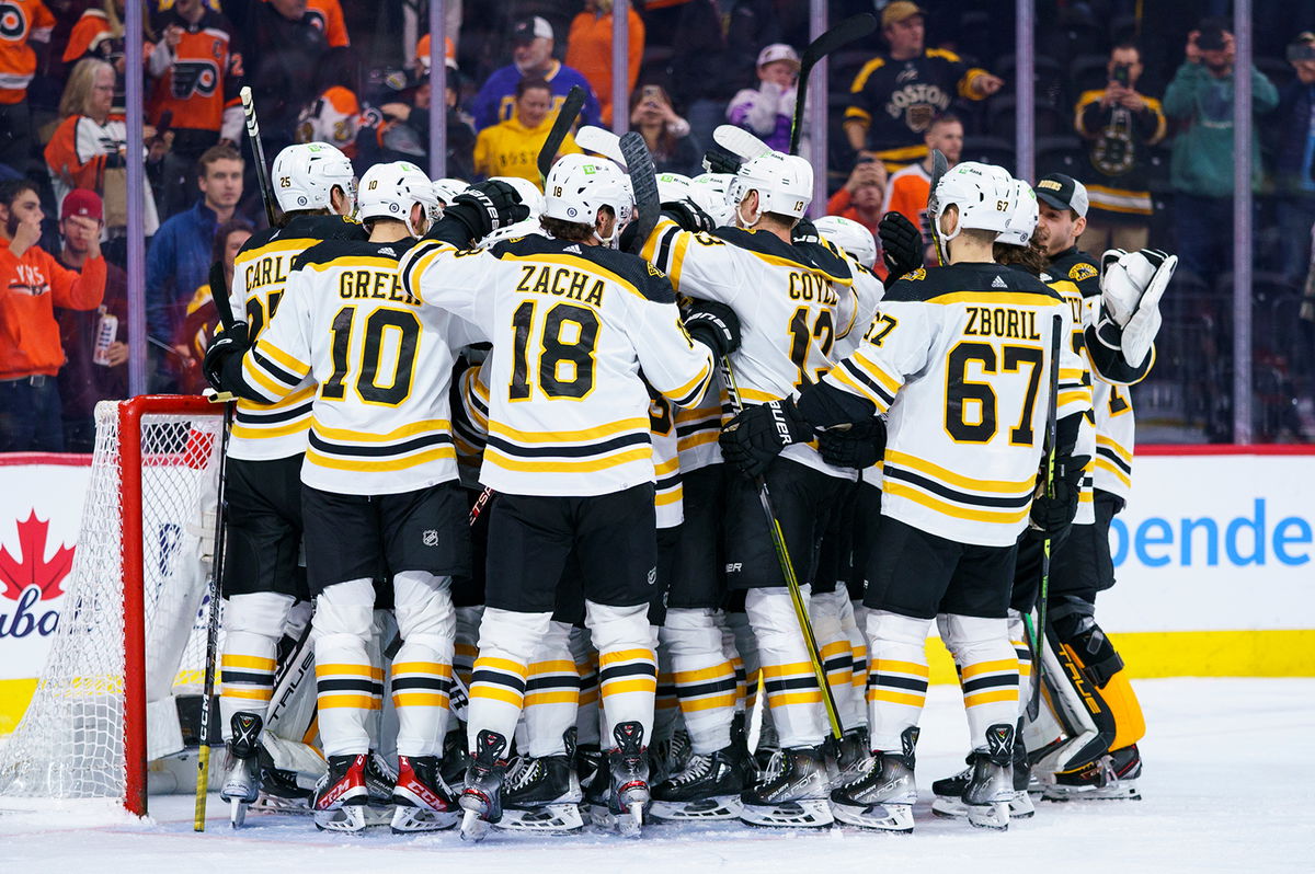 <i>Chris Szagola/AP</i><br/>Boston Bruins gather around Jeremy Swayman as they celebrates their win against the Philadelphia Flyers on Sunday