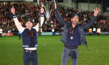 Wrexham owners Rob McElhenney and Ryan Reynolds celebrate after Wrexham won promotion back to the English Football League.