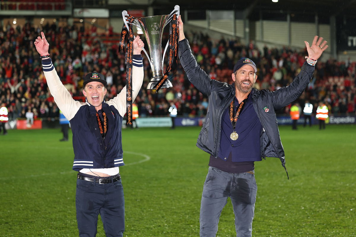 <i>Matthew Ashton/AMA/Getty Images</i><br/>Wrexham owners Rob McElhenney and Ryan Reynolds celebrate after Wrexham won promotion back to the English Football League.