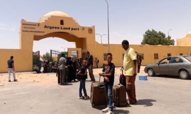 People cross into Egypt from Sudan on April 27
