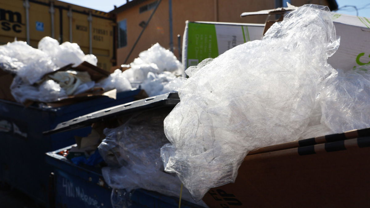 <i>Mario Tama/Getty Images</i><br/>Discarded plastic and other debris overflow from a Los Angeles trash bin. Surfrider Foundation reports less than 7% of plastic gets recycled in the US.